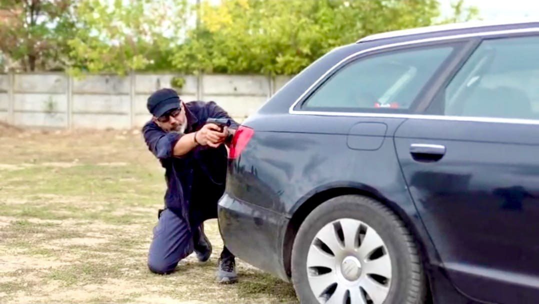 Nexus Praesidium operator shooting from behind a vehicle during operational training
